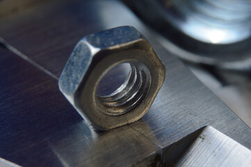 Accurate measuring tool caliper and metal ruler lie in place with nuts. close-up.