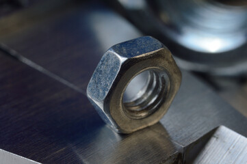 Accurate measuring tool caliper and metal ruler lie in place with nuts. close-up.
