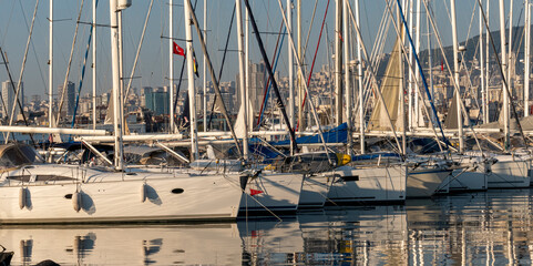 View of marina and yachts with masts taken from opposite angle with selective focus.