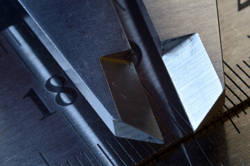 Accurate measuring tool caliper and metal ruler lie on top of each other. close-up.