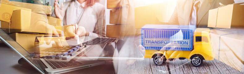 Startup SME small business entrepreneur of freelance Asian woman using a laptop with box Cheerful success Asian woman her hand lifts up online marketing packaging box and delivery SME idea concept