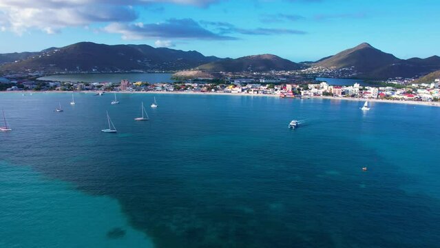 Aerial of Great Bay Beach in Philipsburg, Sint Maarten during calm sunset (straight flight, constant altitude)