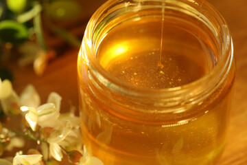 jar of honey with white flowers