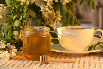 jar of honey with white flowers