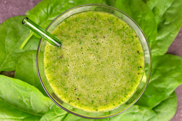 Healthy green smoothie in a glass of kiwi, spinach, avocado, banana and apple. Flat lay. Raw vegan food concept.