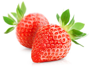 two ripe strawberries with leaves on a white isolated background