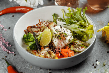 Healthy bowl - quinoa salad with tuna, broccoli, avocado on wooden rustic table. top view
