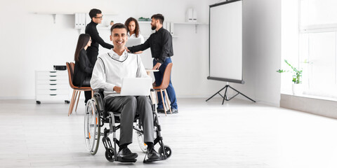 Young man in wheelchair at business meeting in office
