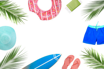Frame made of beach accessories and tropical leaves on white background