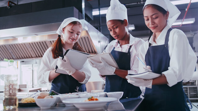 Group of schoolgirls having fun learning to cook. Female students in a cooking class.
