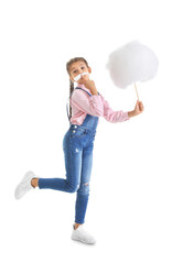 Cute little girl with cotton candy on white background