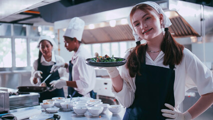 Group of schoolgirls having fun learning to cook. Female students in a cooking class.