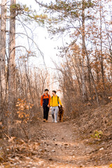 Walking with the dog togeher in the forest while smiling