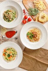 Overhead view of plates with different types of ready to eat pastas