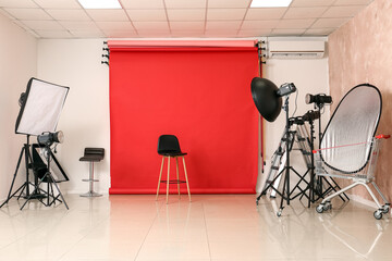 Lighting equipment, chair and cyclorama in modern photo studio