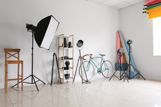 Lighting equipment and bicycle in modern photo studio