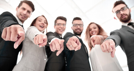 close up.successful business team pointing at you.
