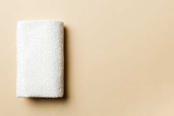 Top view of white towels with copy space on colored background