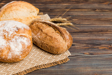 Homemade natural breads. Different kinds of fresh bread as background, perspective view with copy space