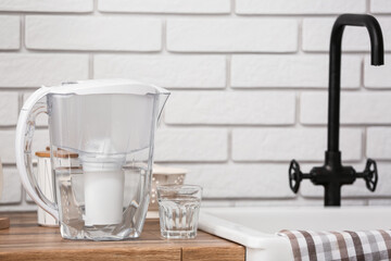 Filter jug and glass of water on counter in kitchen