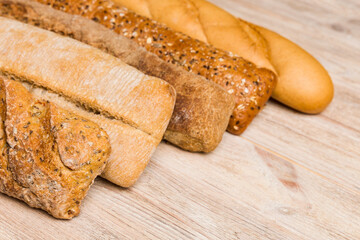 Homemade natural breads. Different kinds of fresh bread as background, perspective view with copy space