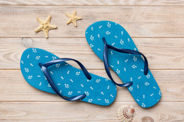 Flat lay composition with flip flops and seashell on colored background. Space for text top view