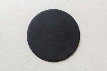 top view of empty black slate plate on cement background. Empty space for your design