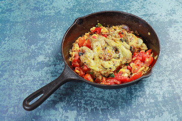 ready to fry chopped onions, tomatoes chilies, egg and barbequed brinjal