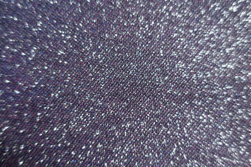 Surface of shiny purple lurex fabric with pink and blue tinges