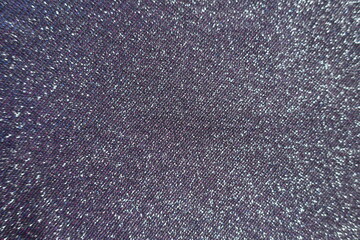 Top view of shiny purple lurex fabric with pink and blue tinges
