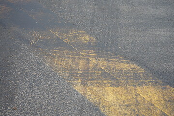Dirty traffic paint from asphalt paving work