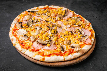 hot delicious traditional italian pizza on a dark stone background