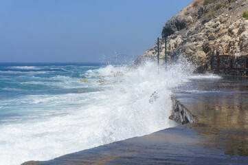 waves crashing against the surf