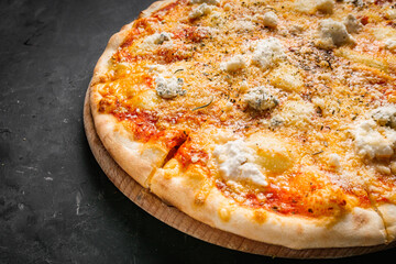 hot delicious traditional italian pizza on a dark stone background