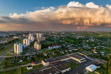 ariel panoramic view of city and skyscrapers with huge storm cloud in the background - obrazy, fototapety, plakaty