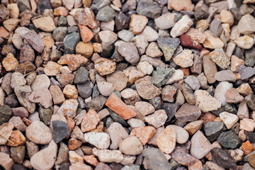 The background is made of stones of different sizes and colors. The texture of natural stones.