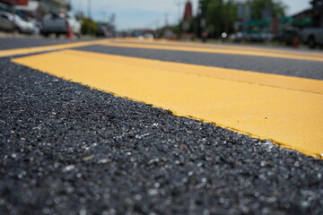 Blurred image, paved road and yellow traffic markings