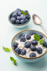 Cottage cheese with blueberry, fresh berries, keto healthy breakfast concept, top view.