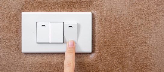 finger turn on or off on light switch on wall at home. Energy Saving, power, electrical and...