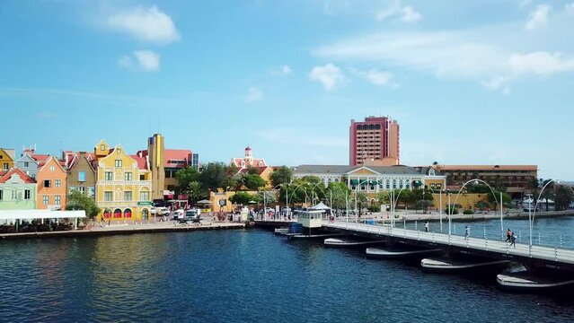 Pan left of the Queen Emma Bridge in St. Anne's Bay and the skyline of the Punta district in Willemstad, Curacao, Dutch Caribbean island.
