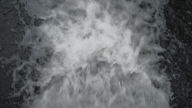 Waterfall on the forest river, view from above. Real time footage, 4k, fast splashing water in a stream