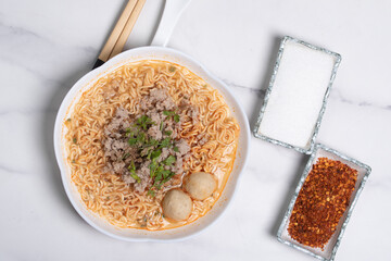 Instant Noodles with Minced Pork Tom Yum in a White Cup