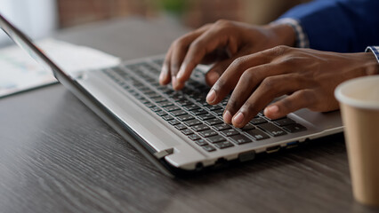 Company manager working with project information on laptop to create online strategy and report for business presentation. Office worker using computer at desk. Close up. Handheld shot.