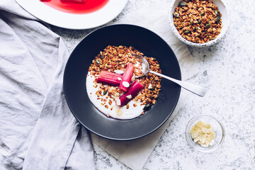 Homemade granola served with yogurt and poached rhubarb