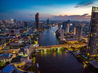Fototapeta na wymiar Aerial view of Saphan Taksin district near the Taksin bridge and Chao Phraya river, Bangkok, Thailand