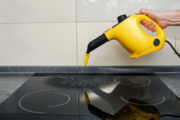 Cleaning of induction cooker with steam cleaner