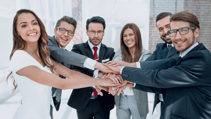 happy business team joining hands together