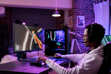 African american streamer broadcasting online video games play on pc, using computer to have fun with esport gaming tournament. Male gamer playing action game championship on internet. © DC Studio