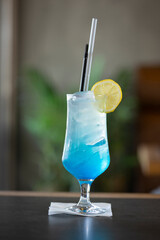 Blue ocean soda drink made of lime or lemon, curacao blue sirup, ice.