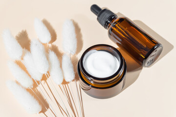 Organic natural cosmetics with dry flowers on beige background. SPA beauty products for skincare, body and hair care. Mockup